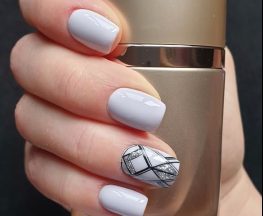 person holding silver and black bottle